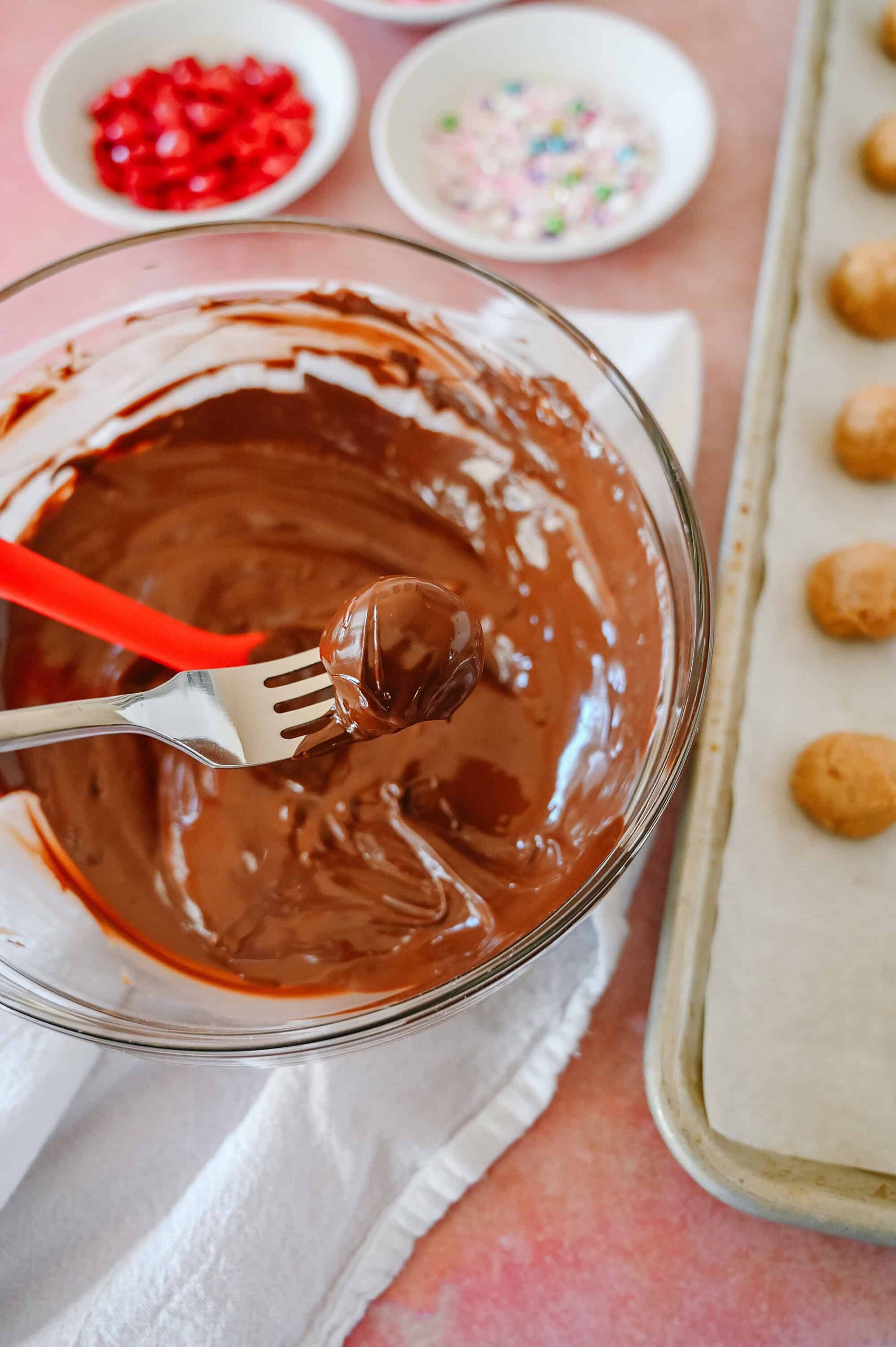 Creamy melted chocolate in a glass bowl, ready for baking or decorating dessert recipes.