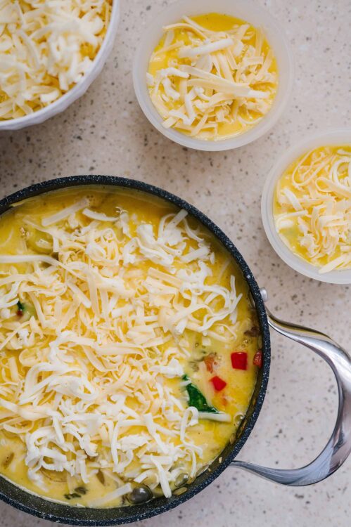 Creamy cheese omelette with shredded cheese, fresh ingredients, cooking, and breakfast recipe.