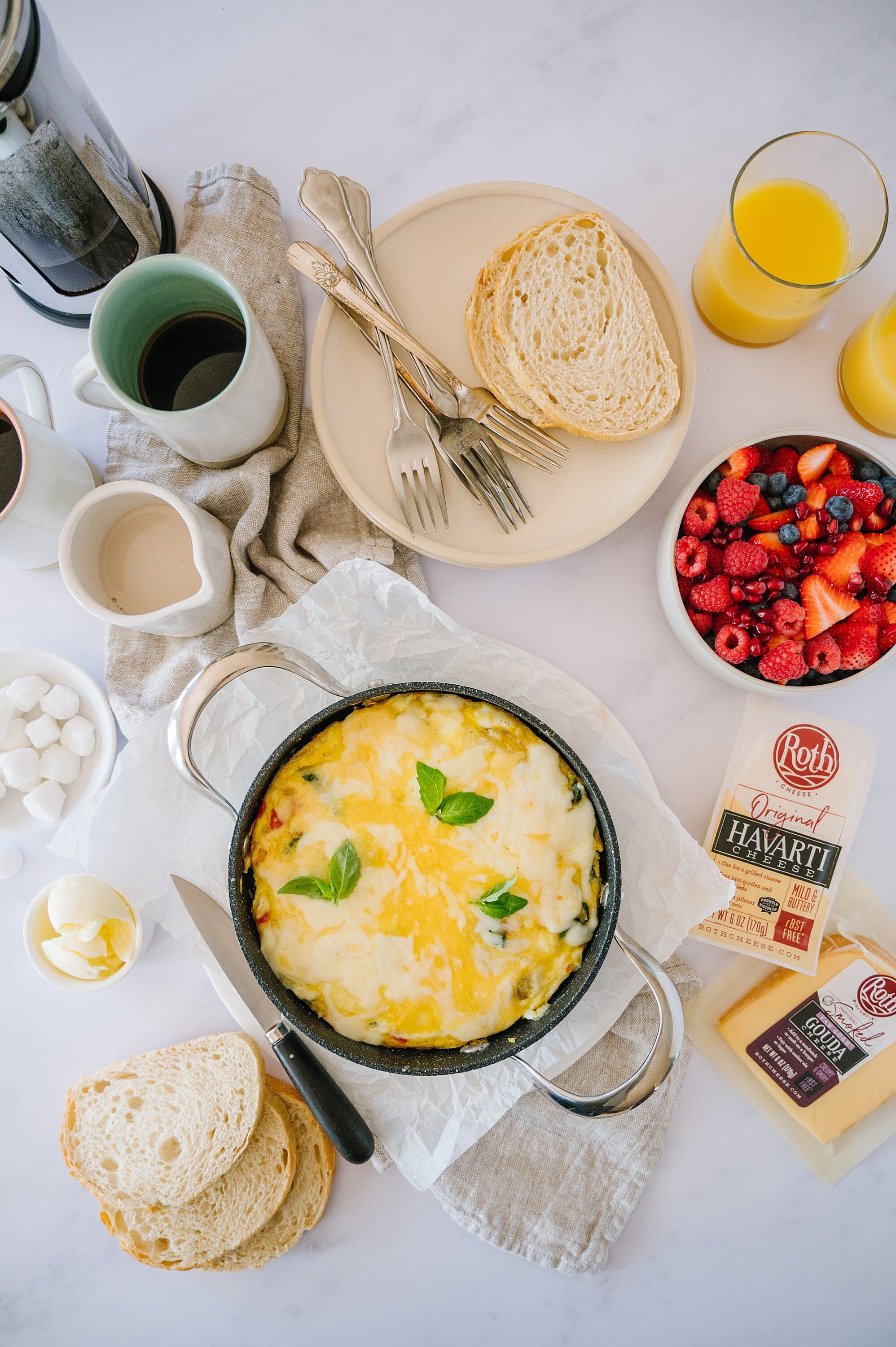 Creamy baked eggs with cheese and herbs served in a cast-iron skillet on a breakfast table.
