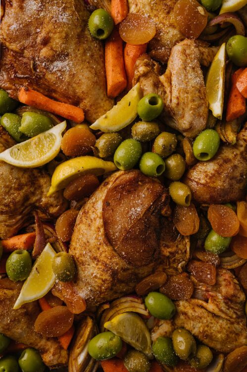 Roasted chicken thighs with lemon and vegetables, close-up, baked Bree recipe.