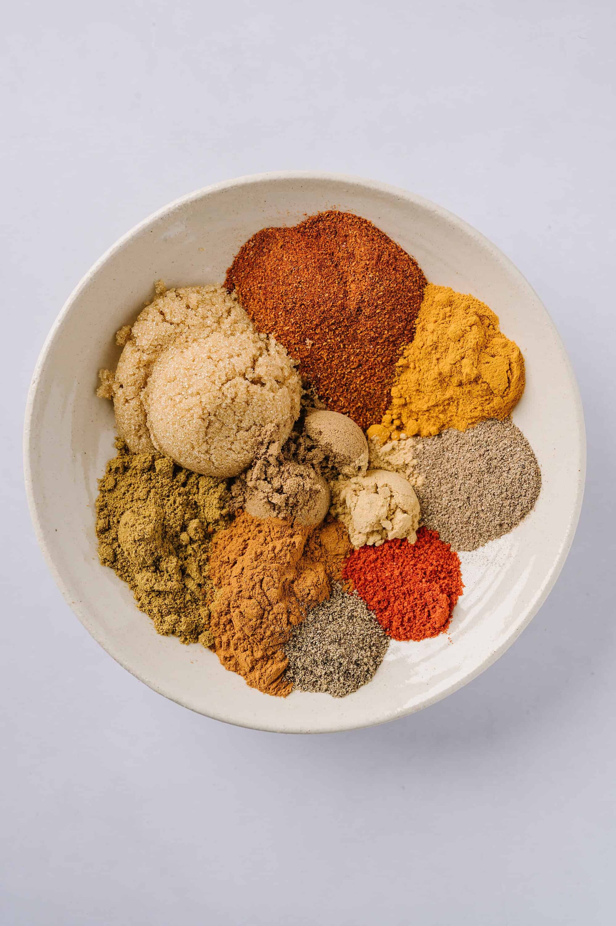 Ground spices and herbs in a white bowl for baking or cooking.