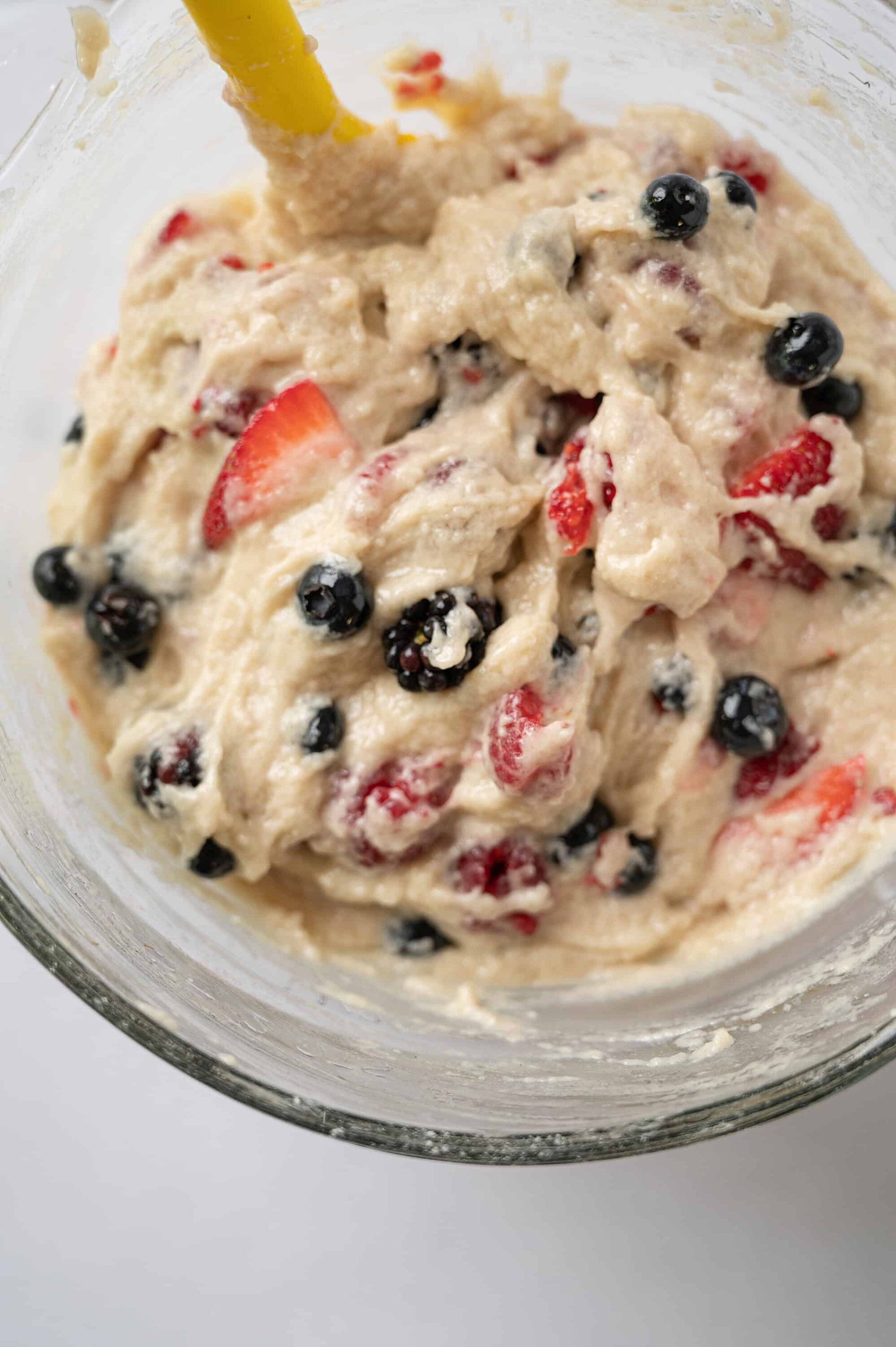 Fresh mixed berry fruit salad in a glass bowl, topped with strawberries, blueberries, and blackberries. Perfect for summer desserts.