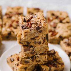 Chewy chocolate chip and pecan cookie bars stacked, homemade dessert recipe, baked treats.