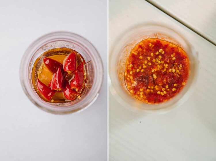 Sliced red chili peppers in vinegar on a white background.