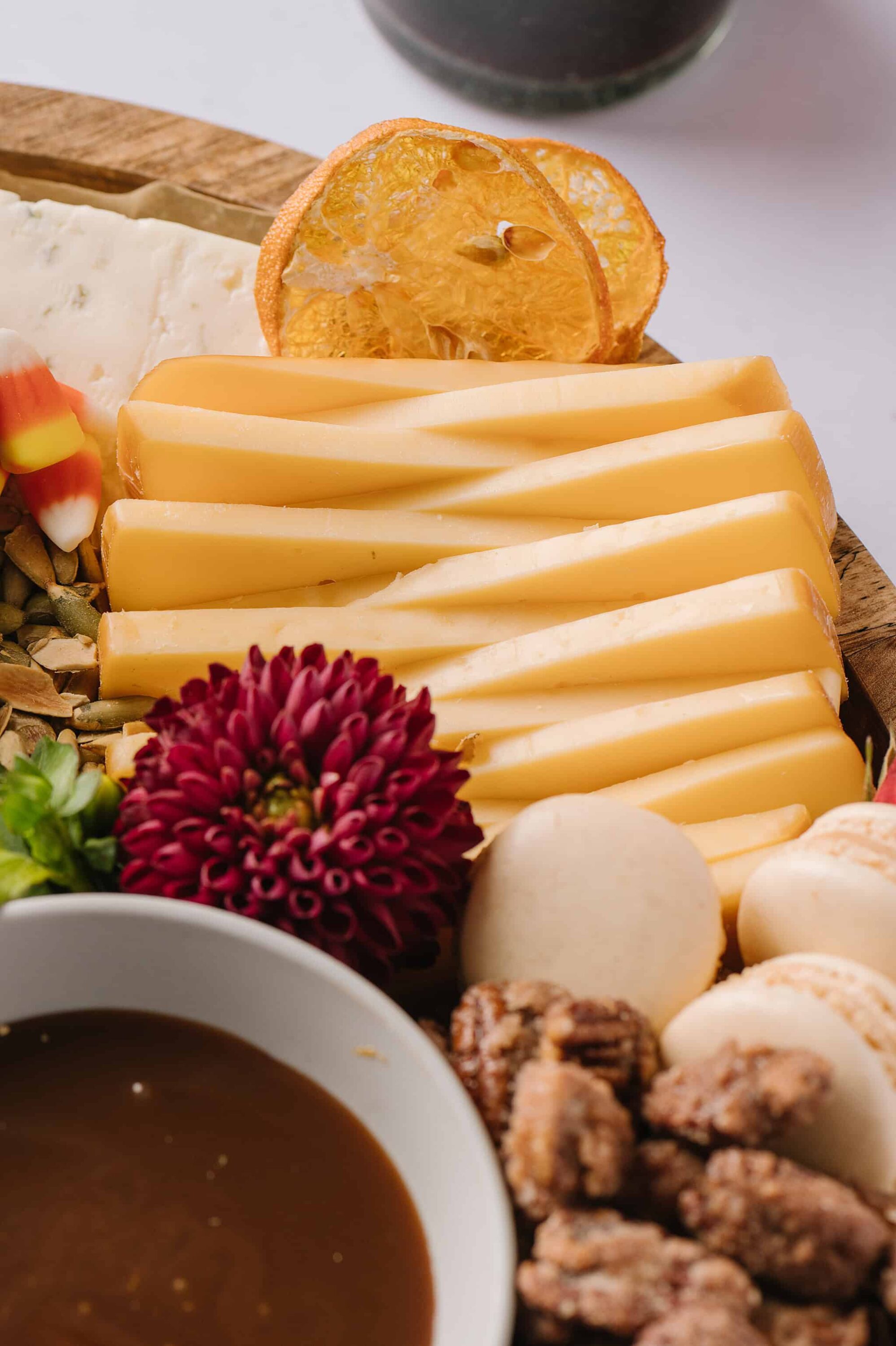 Cheese and charcuterie board with dried fruit, nuts, honey, and accompaniments, perfect for entertaining.
