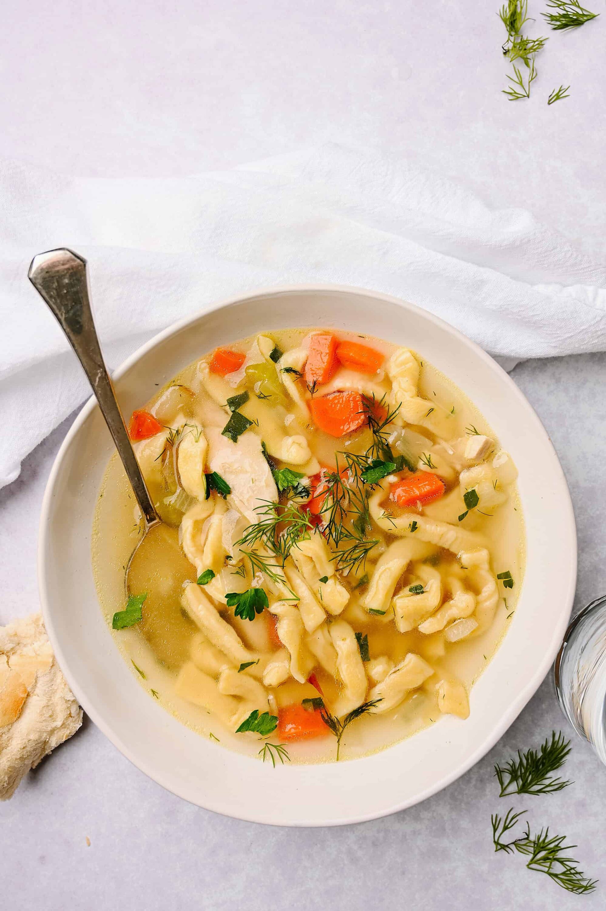 Creamy chicken and vegetable tortellini soup with fresh herbs. Perfect comfort food recipe from Baked Bree.
