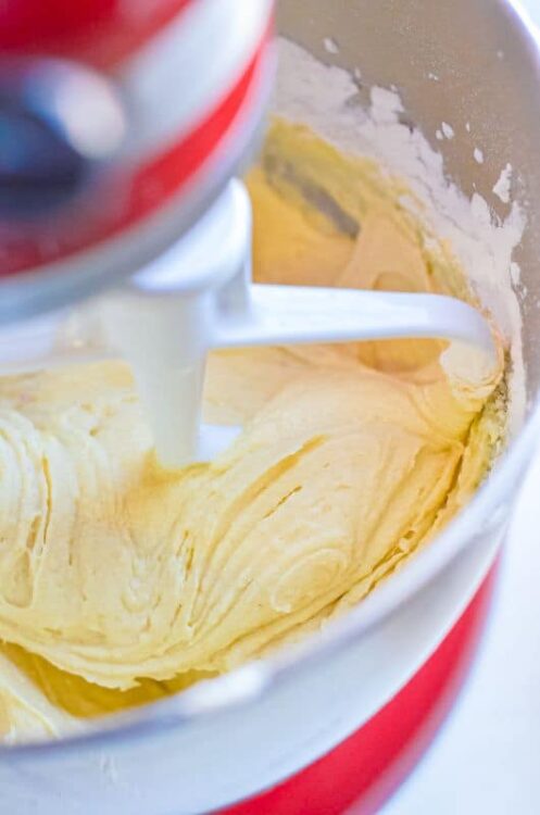 Creamy vanilla cake batter being mixed in a stand mixer for baking recipes.
