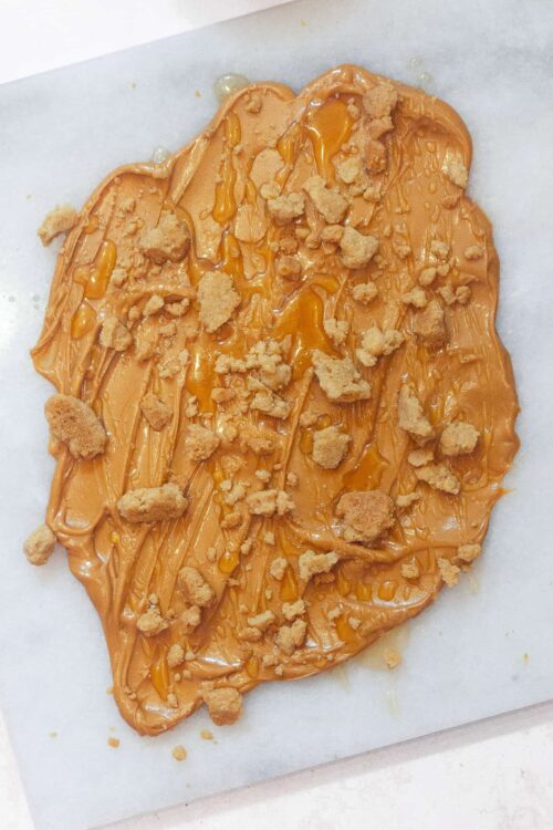 Peanut butter caramel cookie heart with chunks and drizzle, baked to perfection.