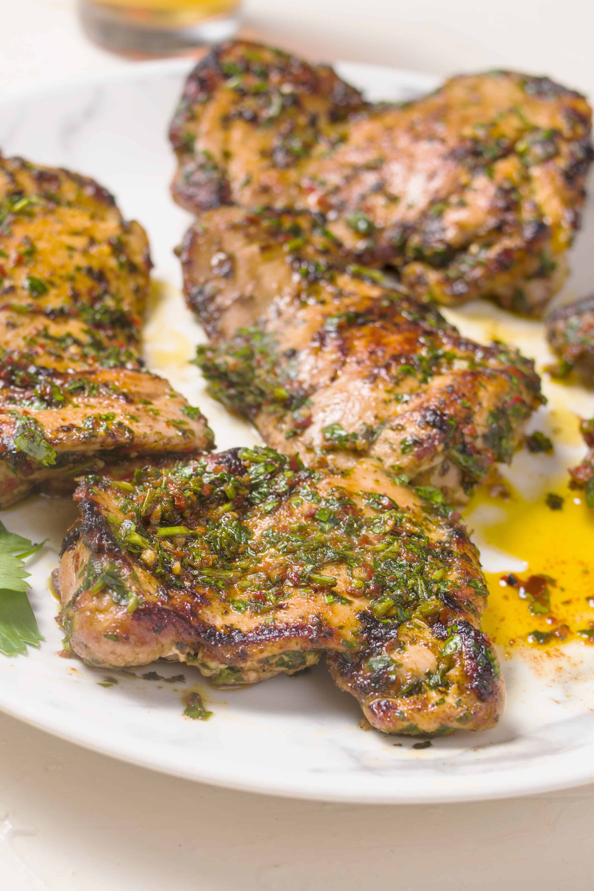 Juicy herb-marinated grilled chicken thighs with fresh herbs and a flavorful glaze.