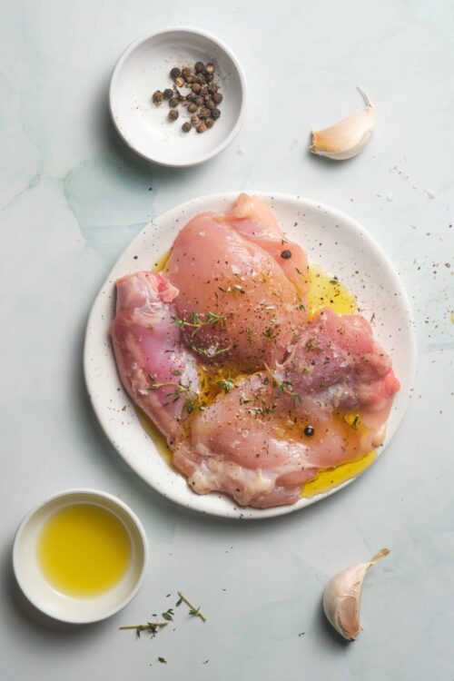 Juice chicken breasts with garlic, herbs, and olive oil for flavorful baked chicken. Perfect for easy dinner recipes and meal prep.