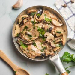 Creamy mushroom chicken skillet with herbs and garlic, cooked to perfection for a delicious meal.