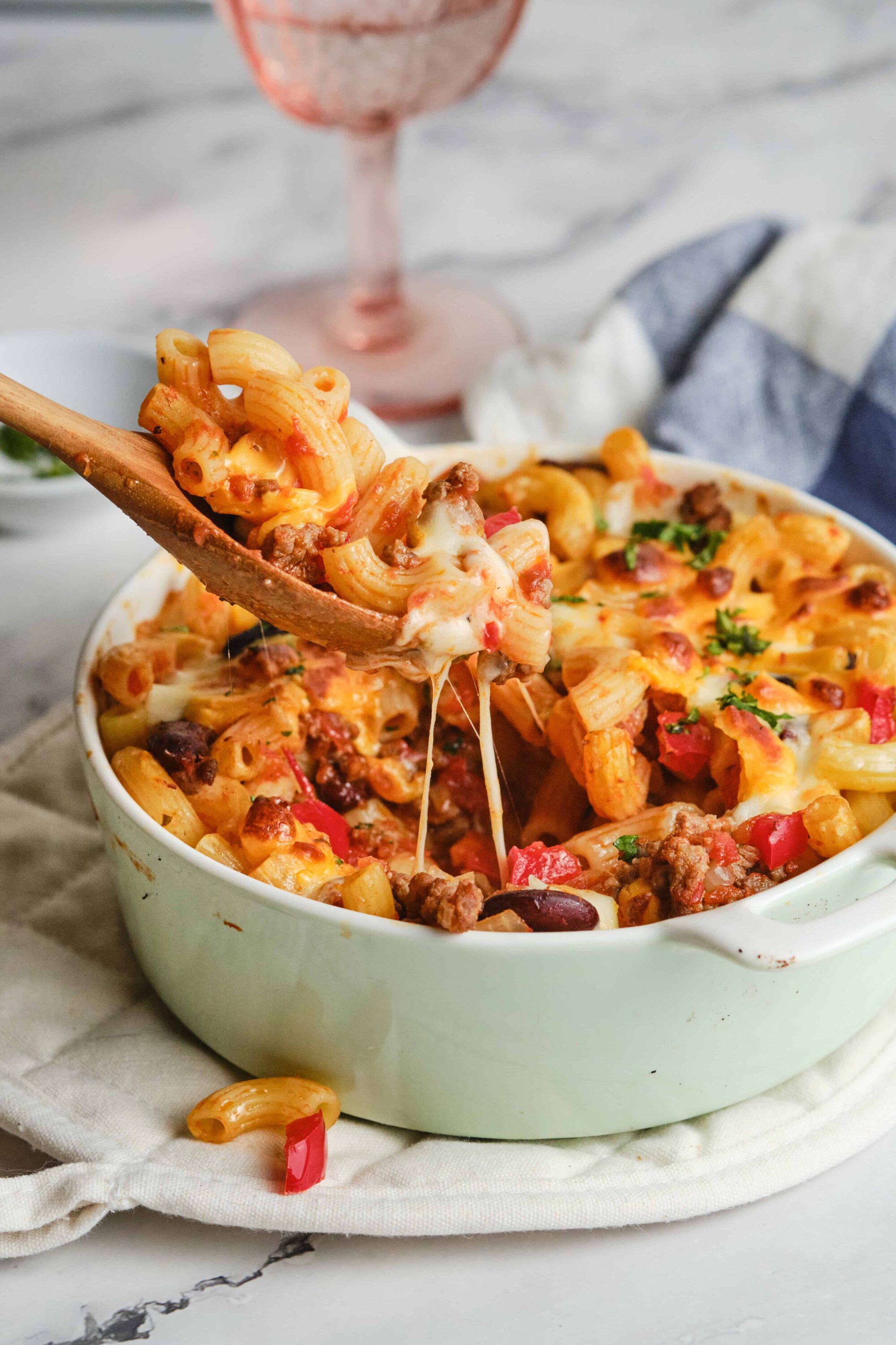 Creamy baked pasta casserole with cheese, ground beef, and fresh herbs. Perfect comfort food recipe from Baked Bree.