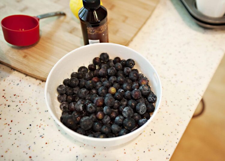 Fresh blueberries in a white bowl for baking or smoothies.
