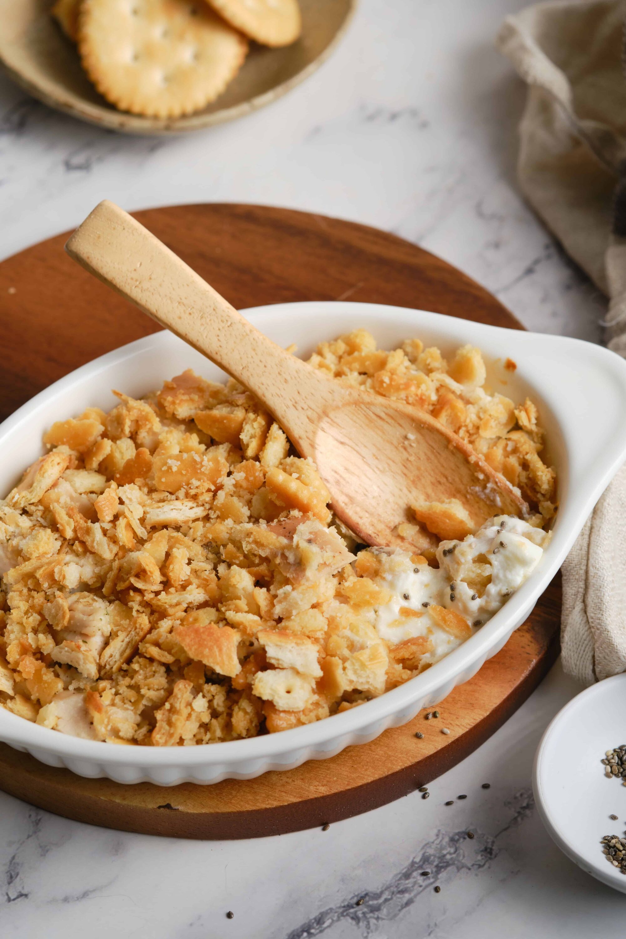 Butter crust apple cobbler in white baking dish with wooden spoon and fresh baked crust topping, homemade dessert, baked bree.