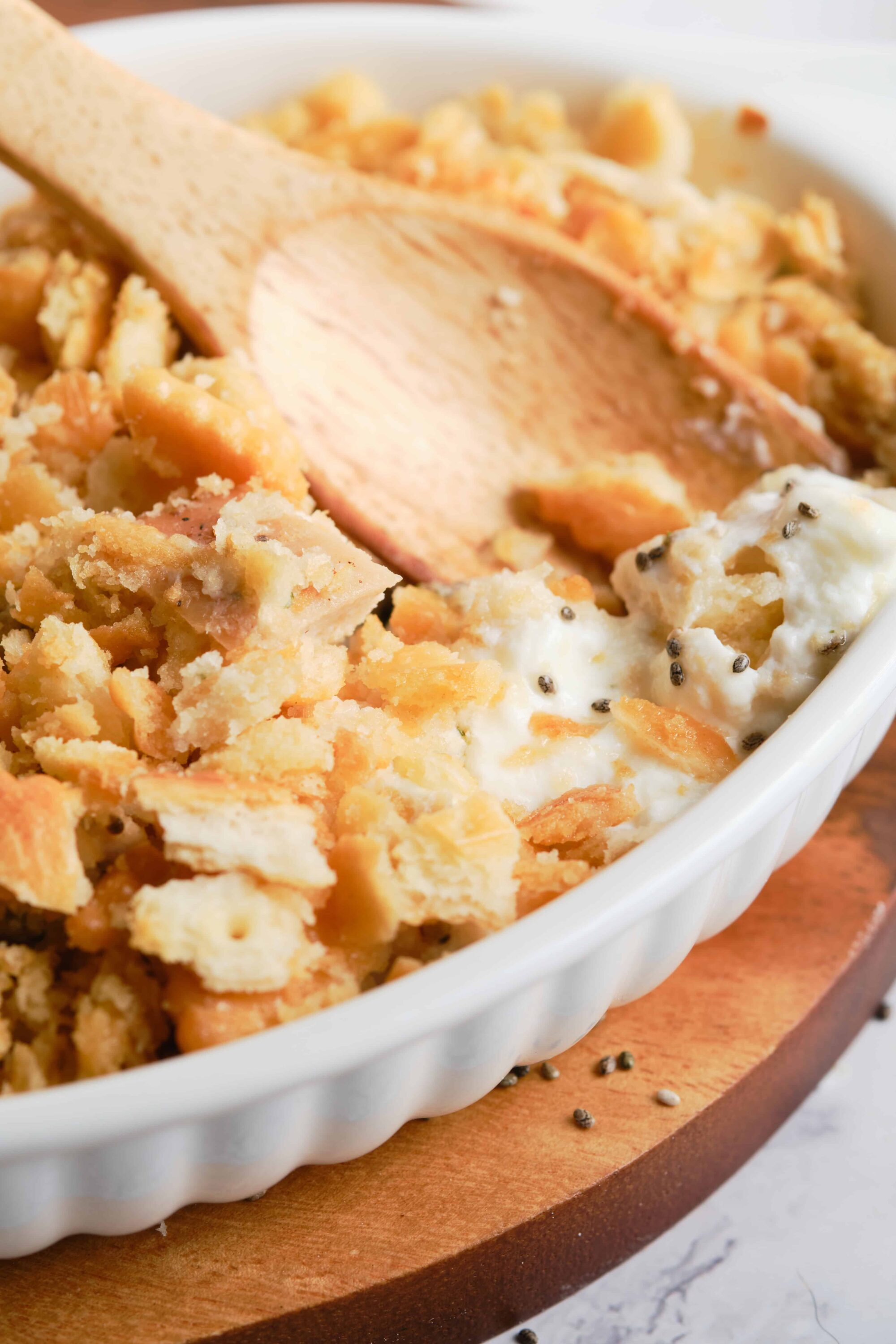 Buttermilk ranch chicken casserole with crispy topping and creamy sauce, baked in a white ceramic dish.