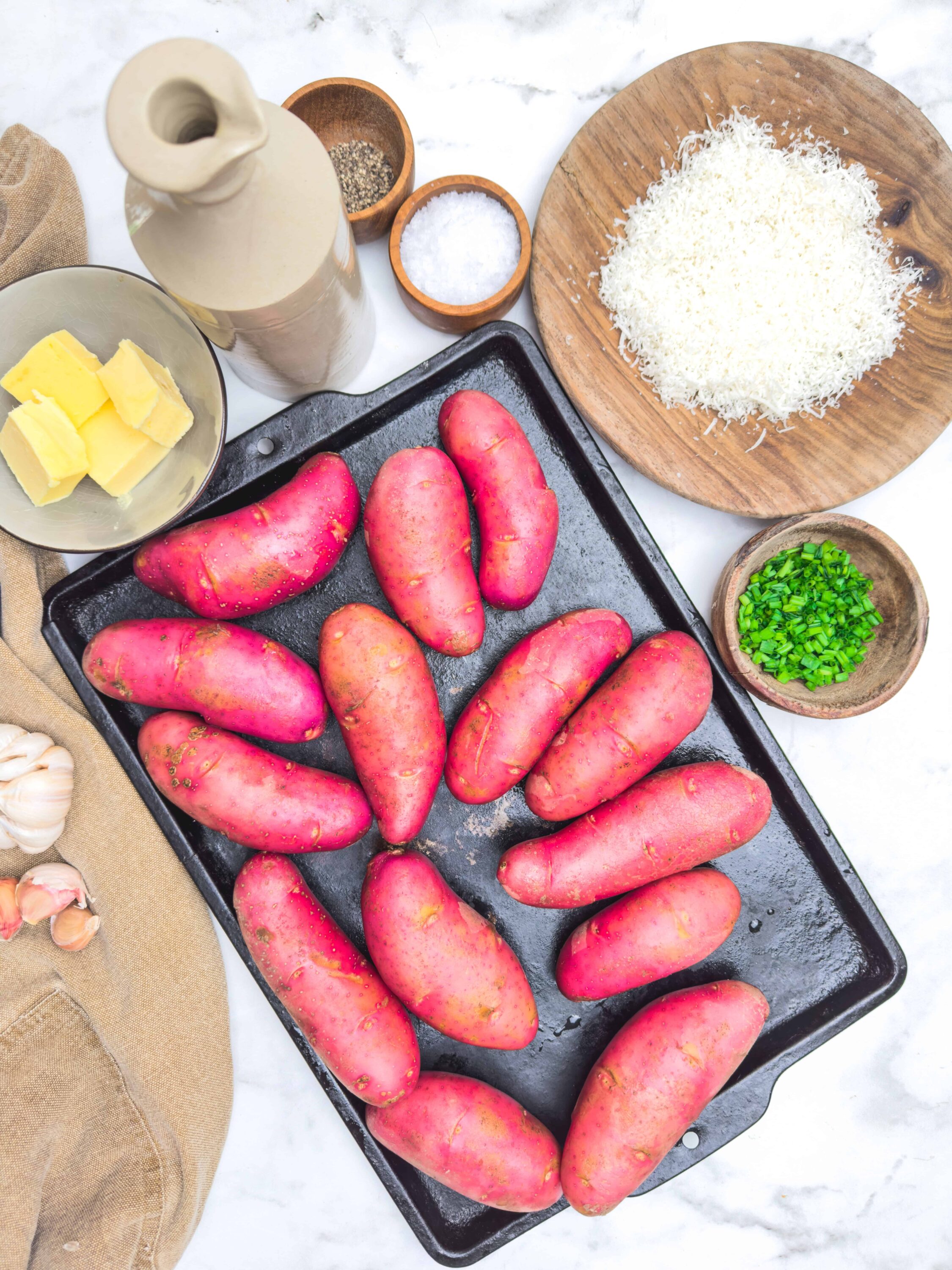Fresh red potatoes on a baking sheet ready for roasting or baking.