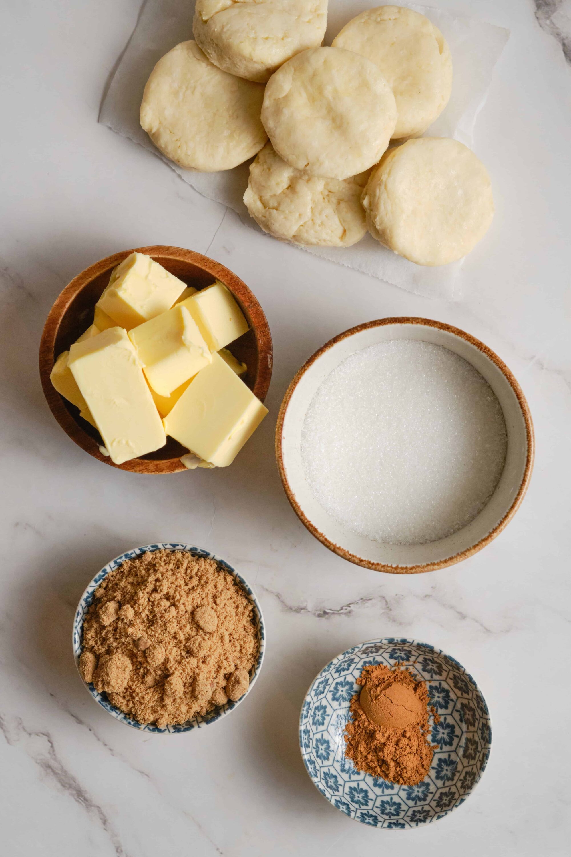 Flaky biscuit dough, butter, sugar, and spices for homemade baking.