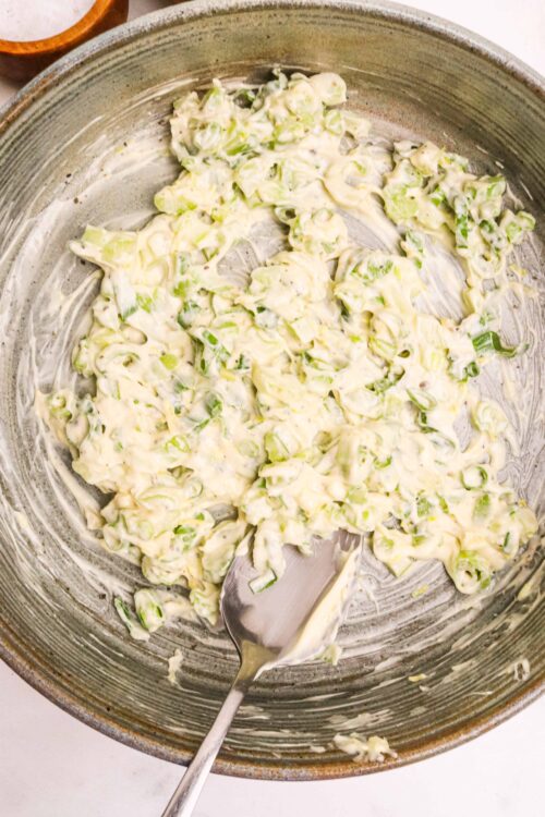 Creamy chopped leek salad in skillet, fresh and flavorful, perfect for spring or summer meals.