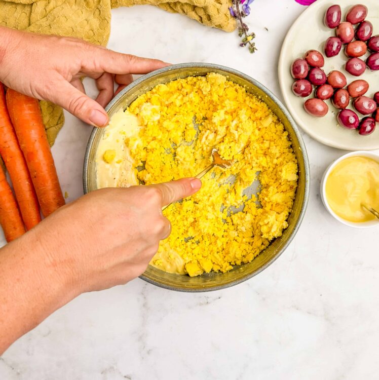 Butternut squash mashed with butter in a mixing bowl for a flavorful side dish.