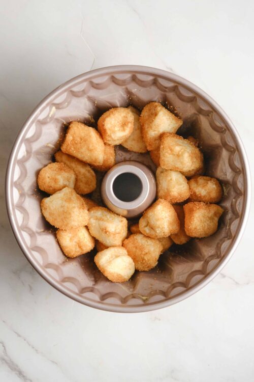 Golden baked chicken nuggets in a food processor bowl.