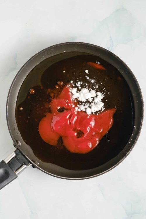 Rich tomato sauce with ricotta cheese and spices in a skillet.
