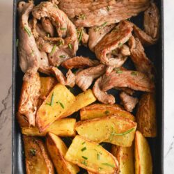 Sautéed steak and roasted potatoes on a baking sheet for easy dinner recipes.