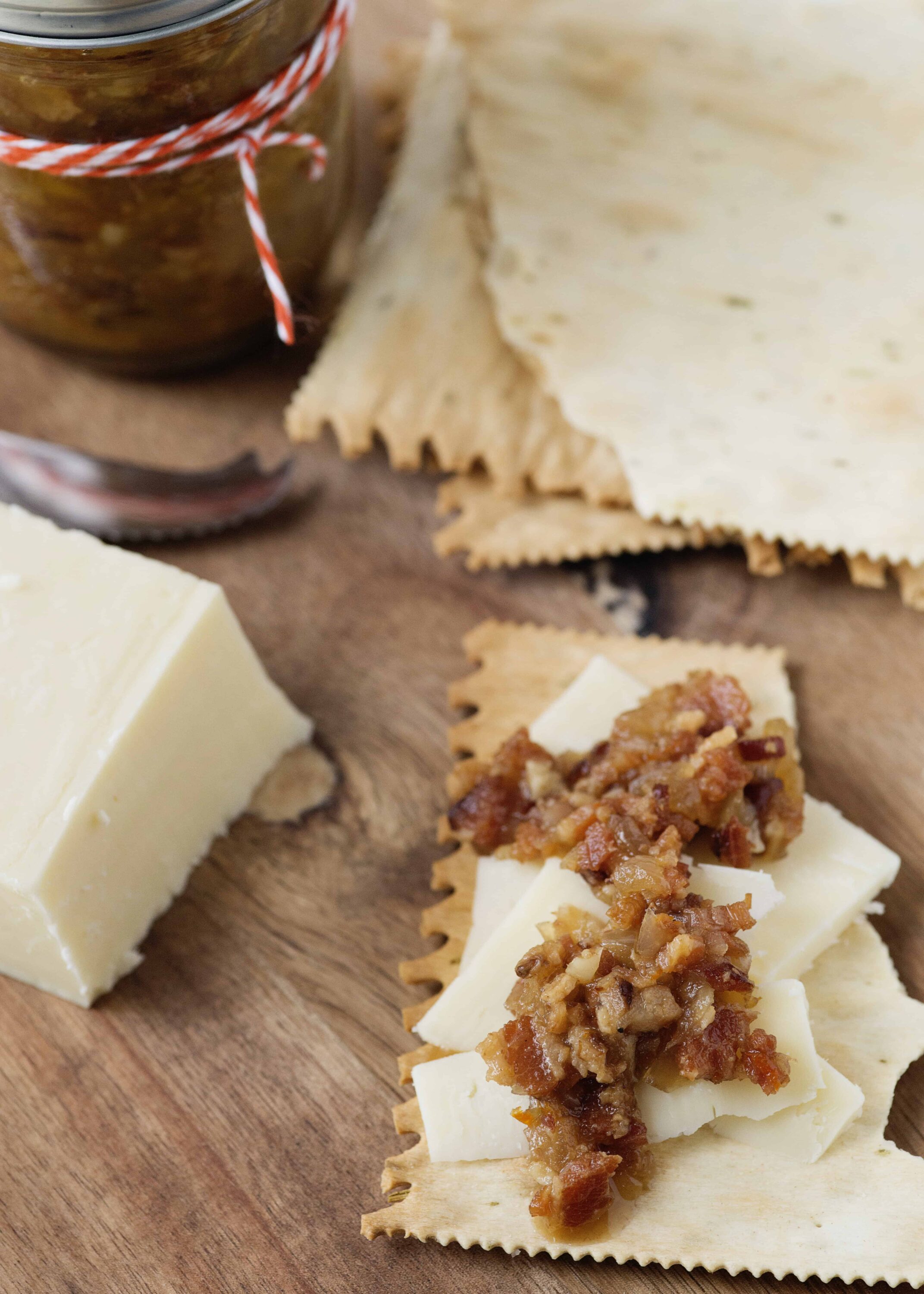 Golden cheese and caramelized onion sauce layered on uncooked lasagna noodles.