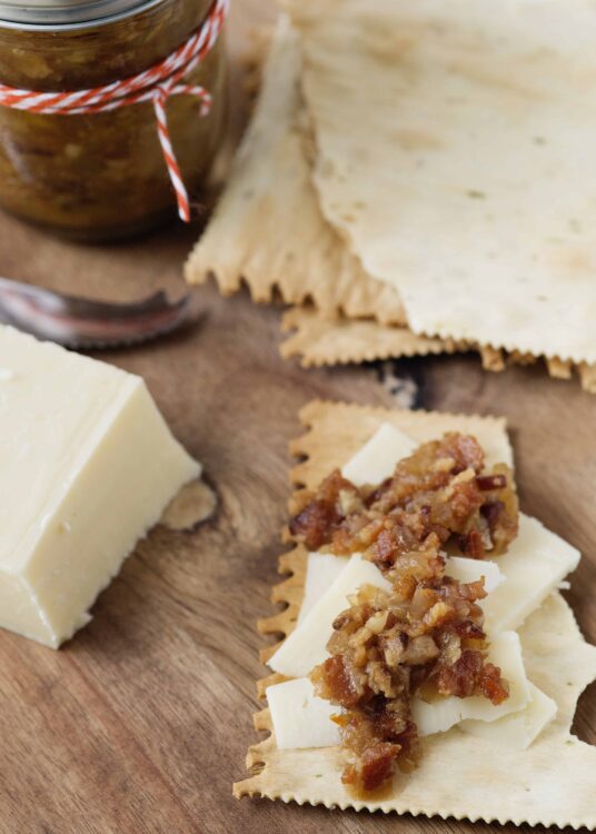 Golden cheese and caramelized onion sauce layered on uncooked lasagna noodles.