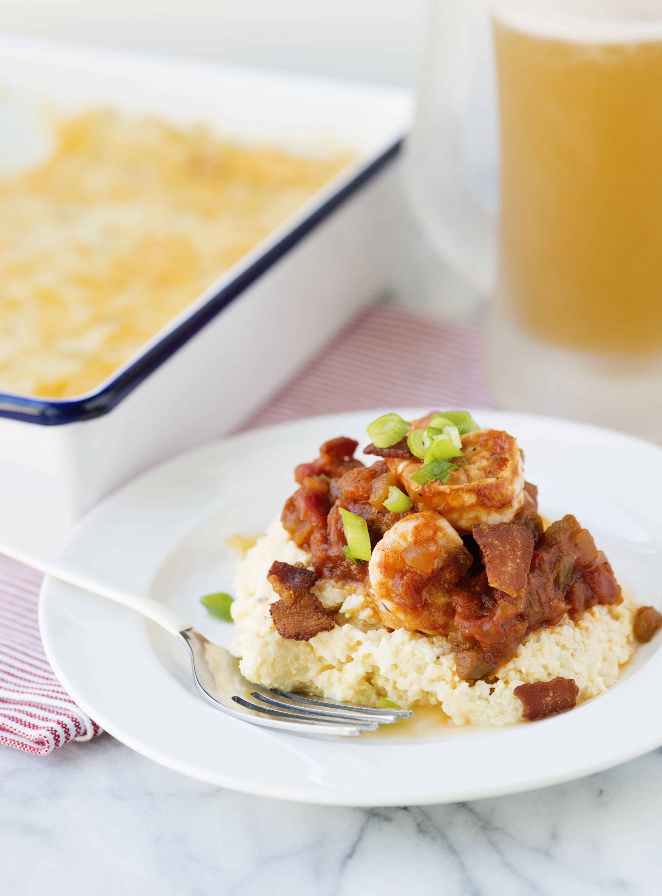 Savory chicken and bacon with diced green onions on mashed potatoes, baked in a casserole dish.