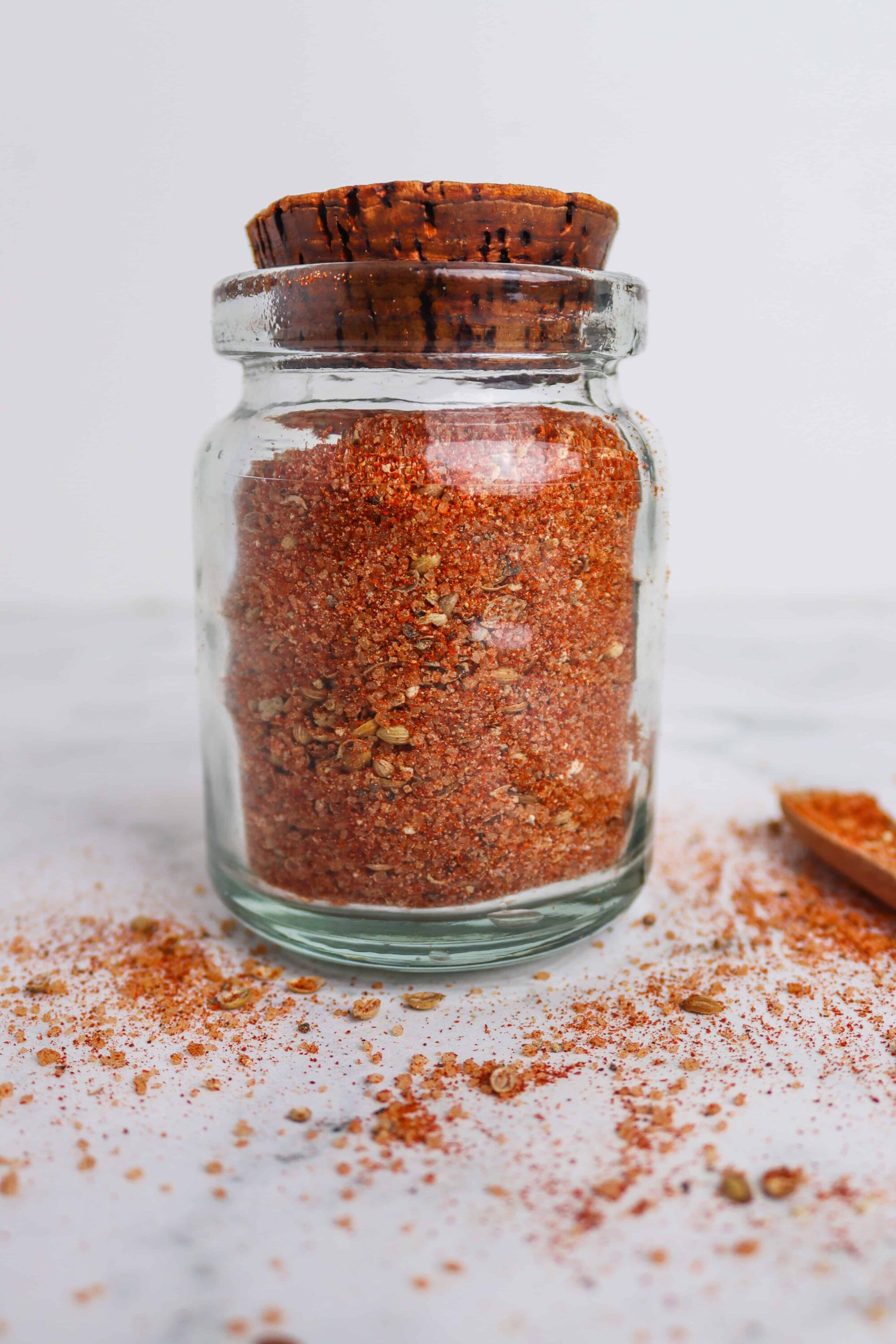Ground spice mix in a glass jar with a wooden lid, ready for baking and cooking.