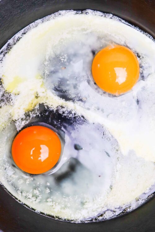 Eggs frying in a skillet for baking or breakfast recipes.