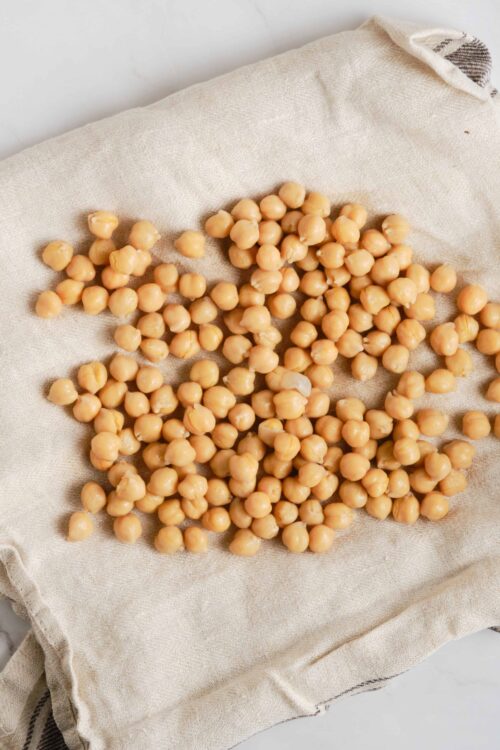 Roasted chickpeas on a beige cloth, ready as a healthy snack.