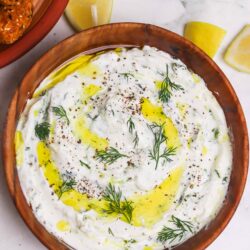 Creamy herbed tzatziki sauce topped with olive oil and dill. Perfect for dips or sauces with fresh ingredients.