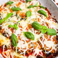 Savory baked eggplant Parmesan with melted cheese and fresh basil. Perfect comfort food recipe from Baked Bree.