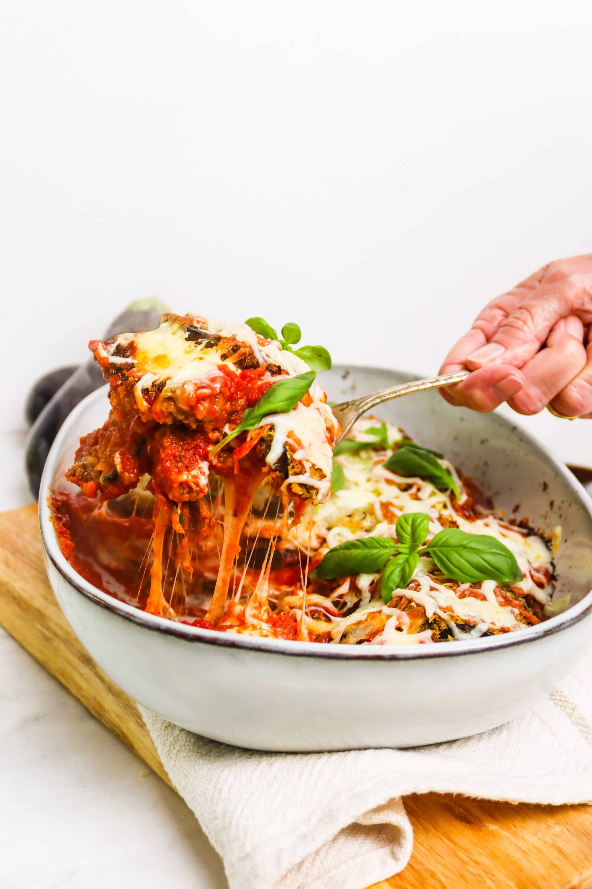 Cheesy baked eggplant Parmesan with fresh basil on top, classic Italian comfort food.