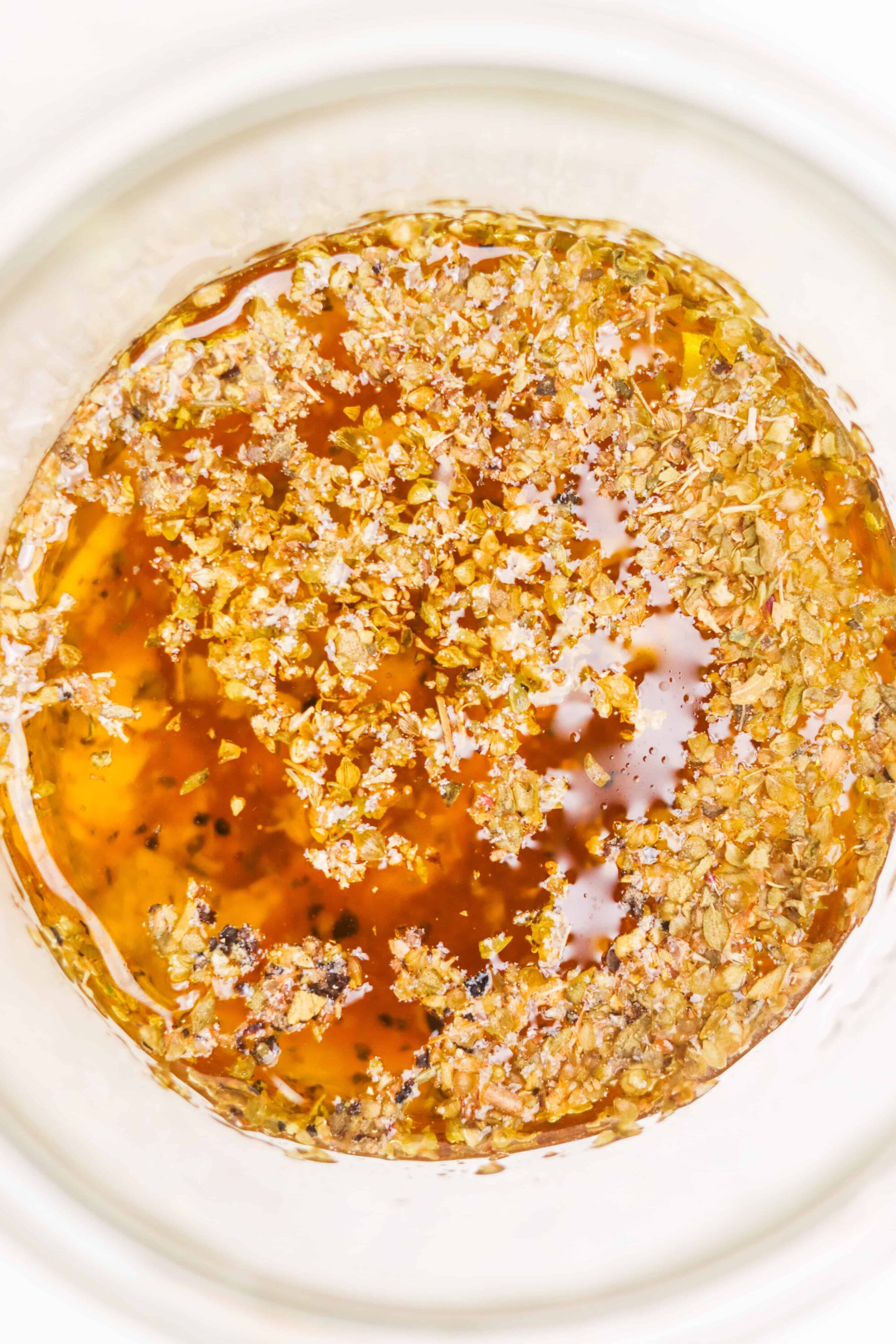 Golden caramel sauce garnished with chopped nuts for decadent dessert topping.