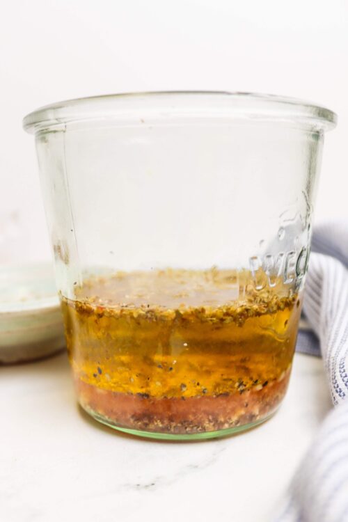 Golden honey mustard vinaigrette in a clear glass jar, ready for salad dressing or marinade.