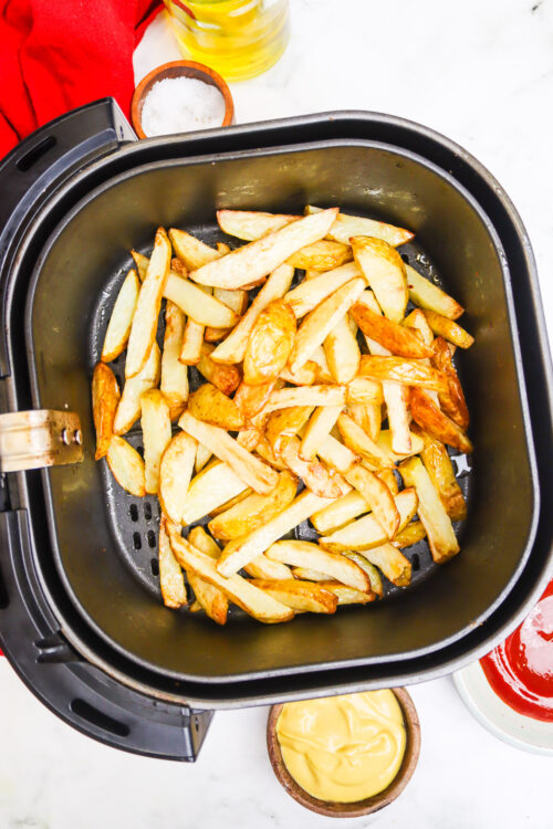 Crispy homemade French fries cooked in an air fryer with golden edges. Perfect for snacking or serving with burgers.