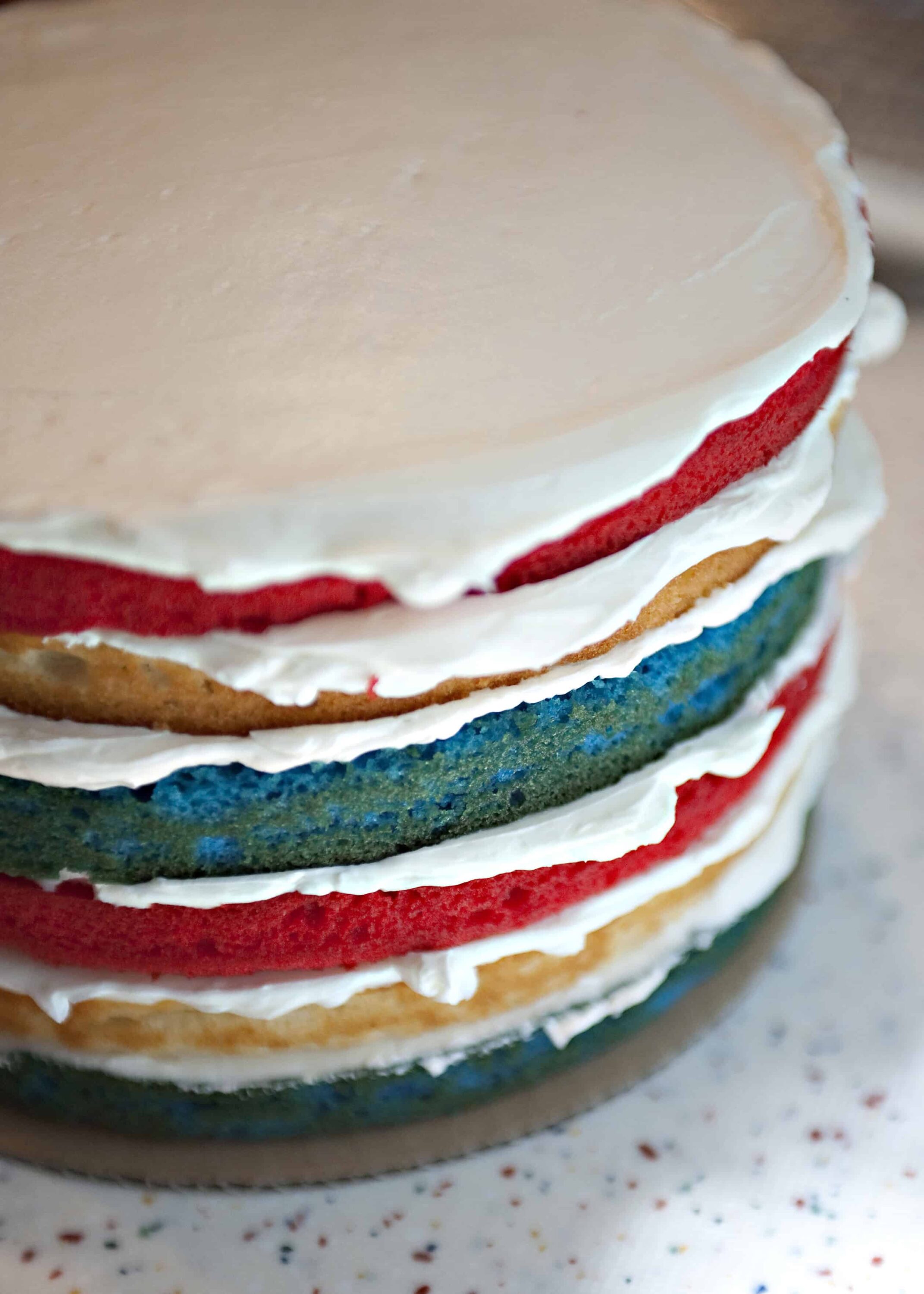 Colorful layered cookies with white frosting and vibrant icing, perfect for decorating and special occasions.