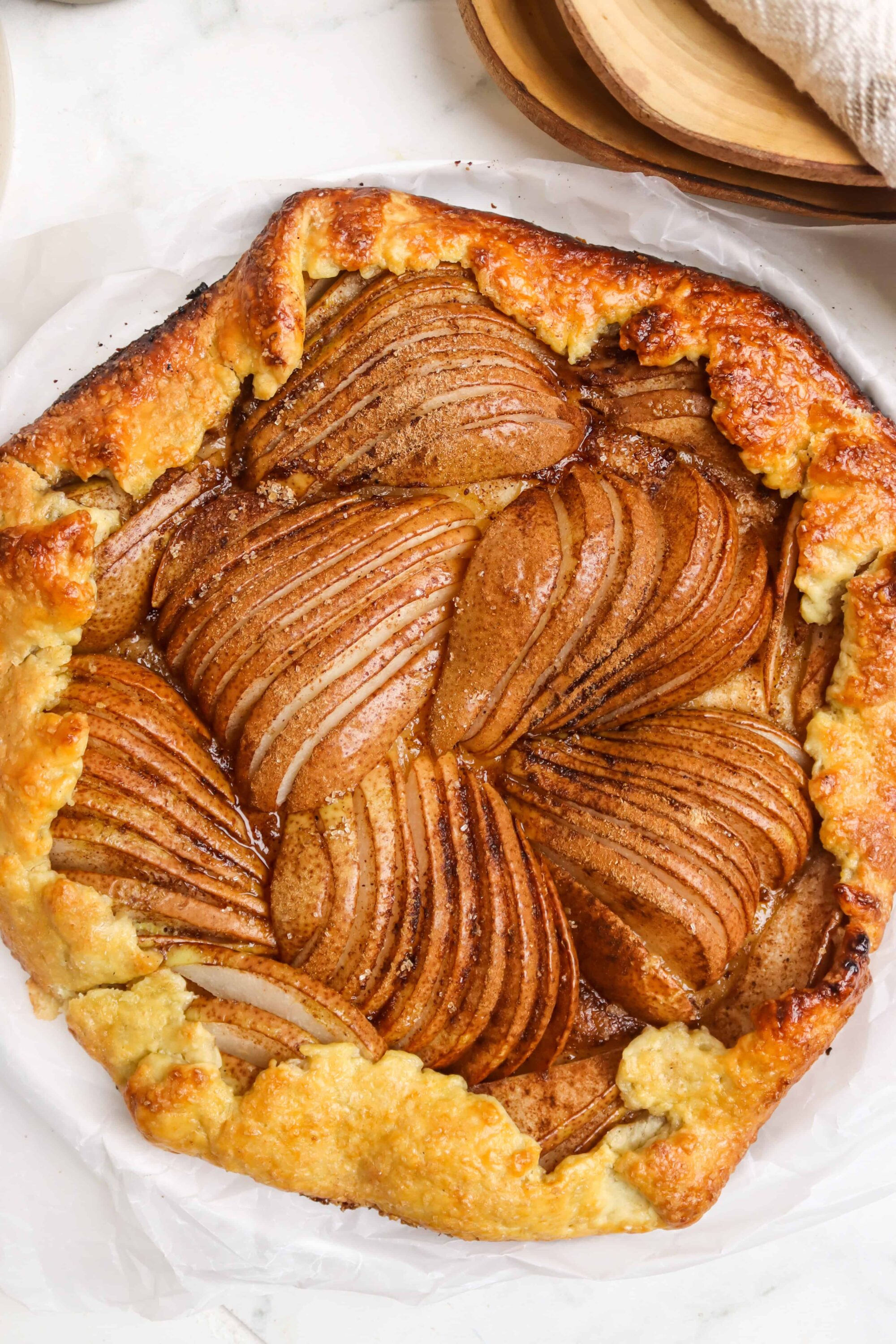 Buttery pear tart with cinnamon-spiced pears and flaky pastry crust. Perfect for autumn desserts and pie lovers.