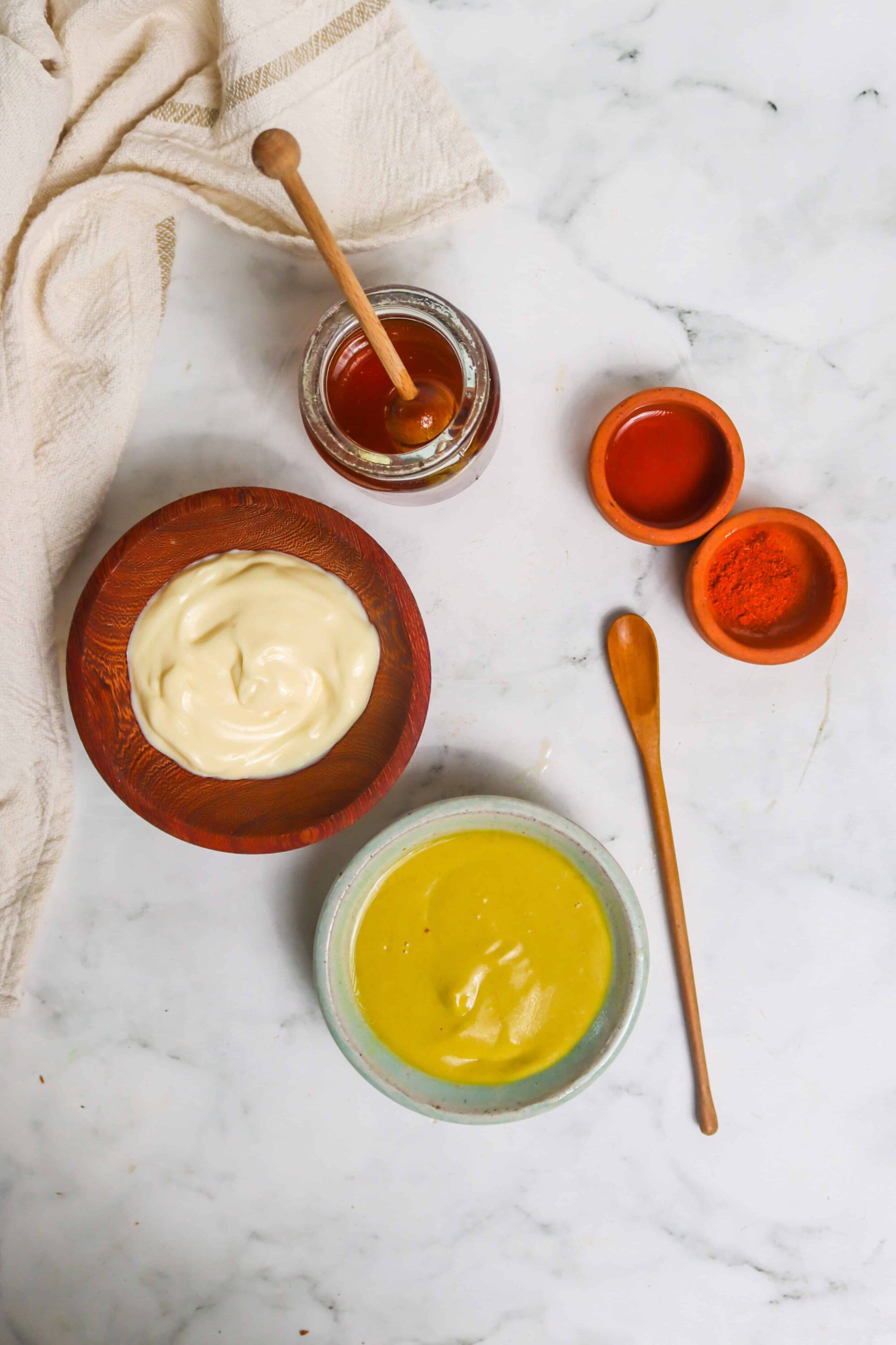 Sweet and savory sauces and honey on marble surface, perfect for baking recipes.