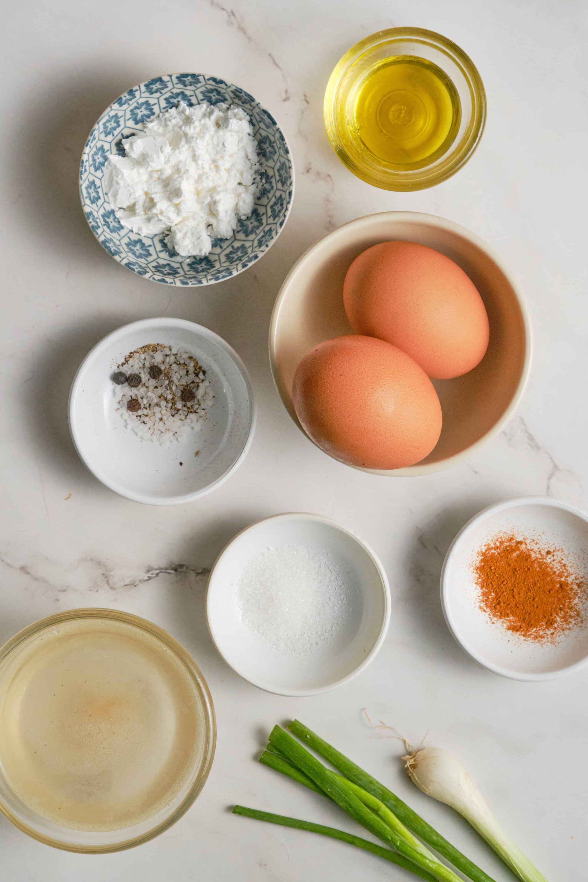 Soft-boiled eggs with fresh scallions, oil, and seasonings for breakfast or cooking.