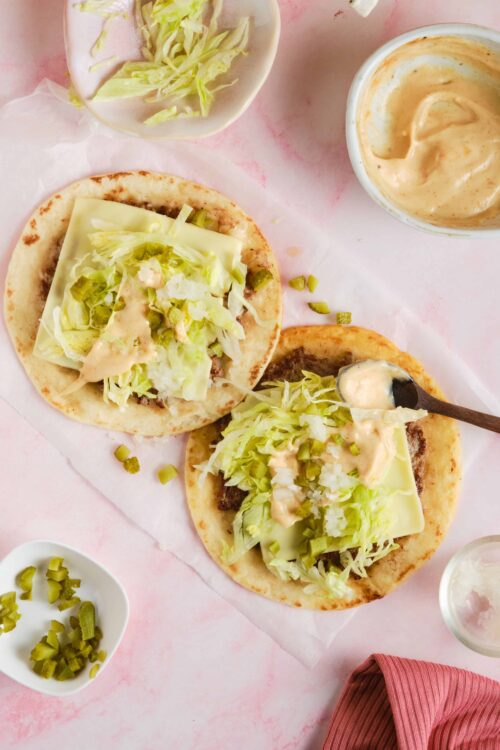 Succulent beef tacos with fresh lettuce, cheese, and creamy sauce on soft tortillas. Perfect for quick, flavorful homemade tacos.