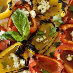 Roasted colorful bell peppers with blue cheese, fresh basil, and chopped green onions.