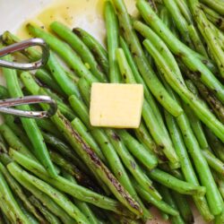 Roasted green beans with butter in a skillet, ready to serve.
