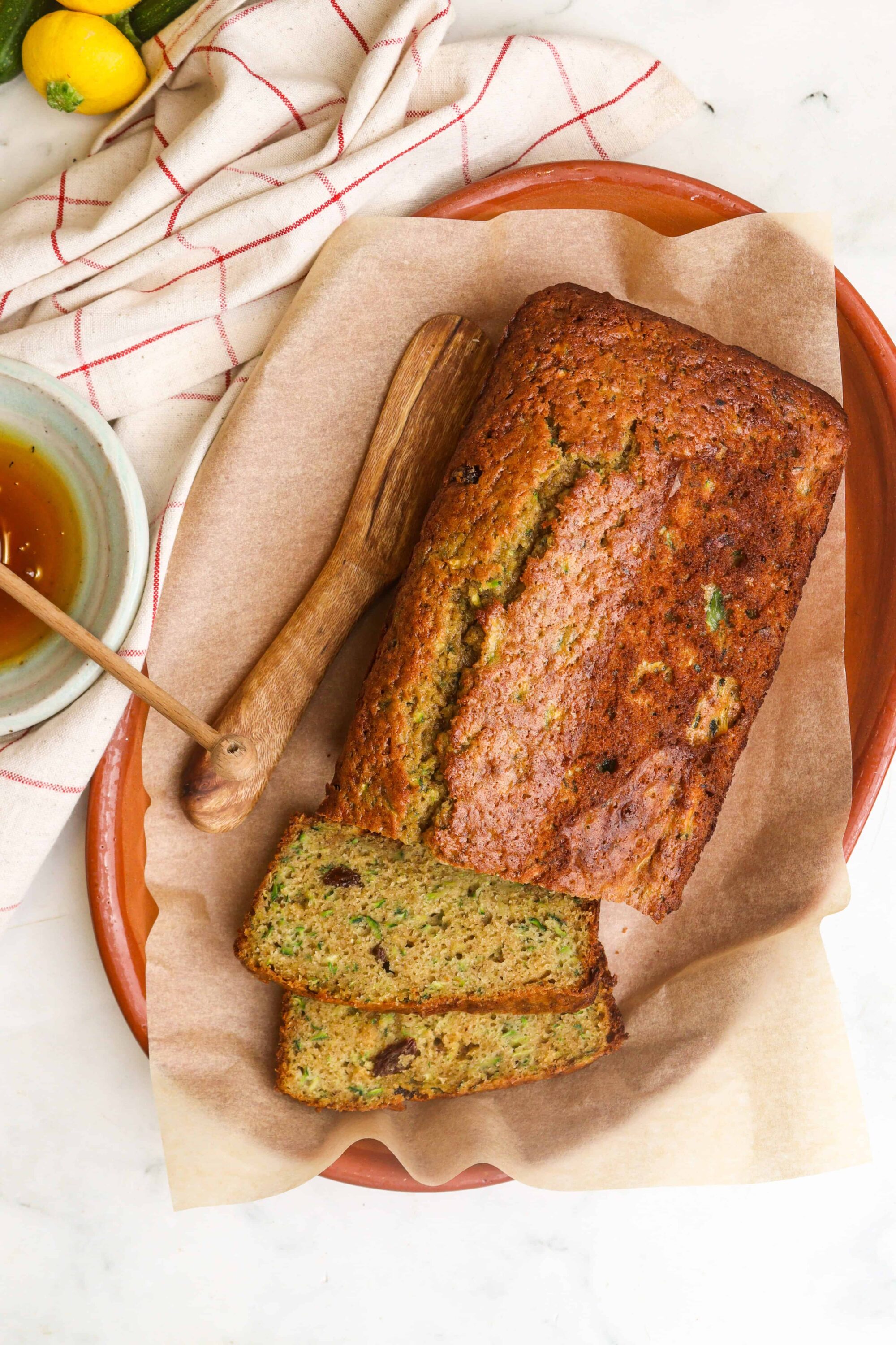 Buttermilk zucchini bread with raisins on a baking sheet.