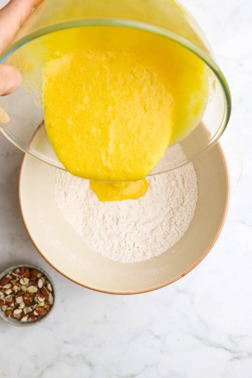 Flour and lemon batter for baking on a marble countertop.