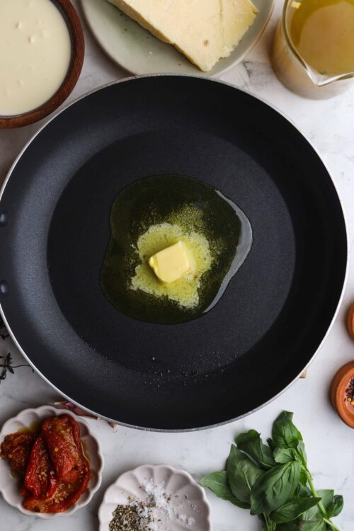 Golden melting butter in a skillet for cooking recipes.