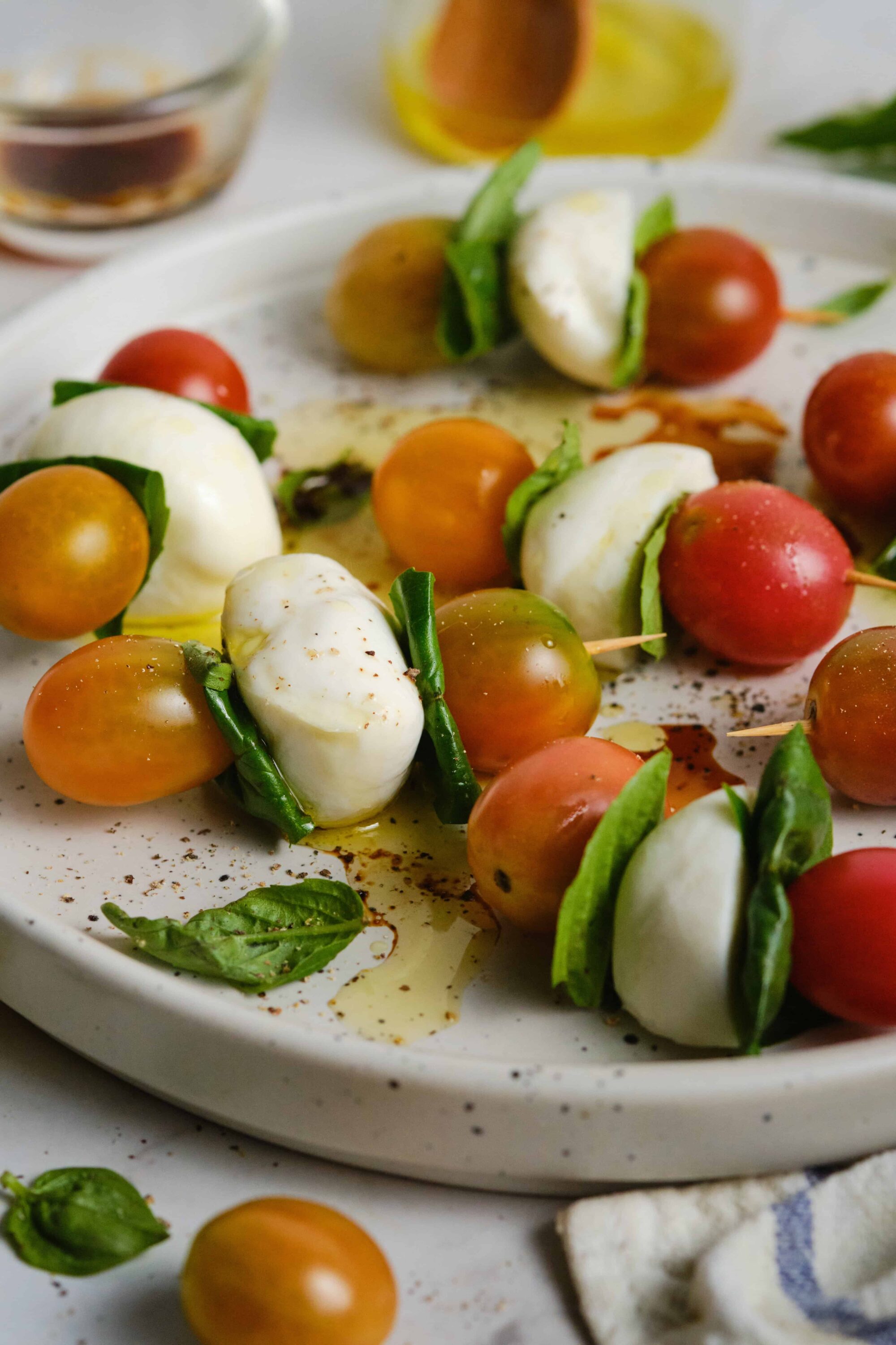 Fresh Caprese Salad Skewers with Cherry Tomatoes, Burrata, and Basil.