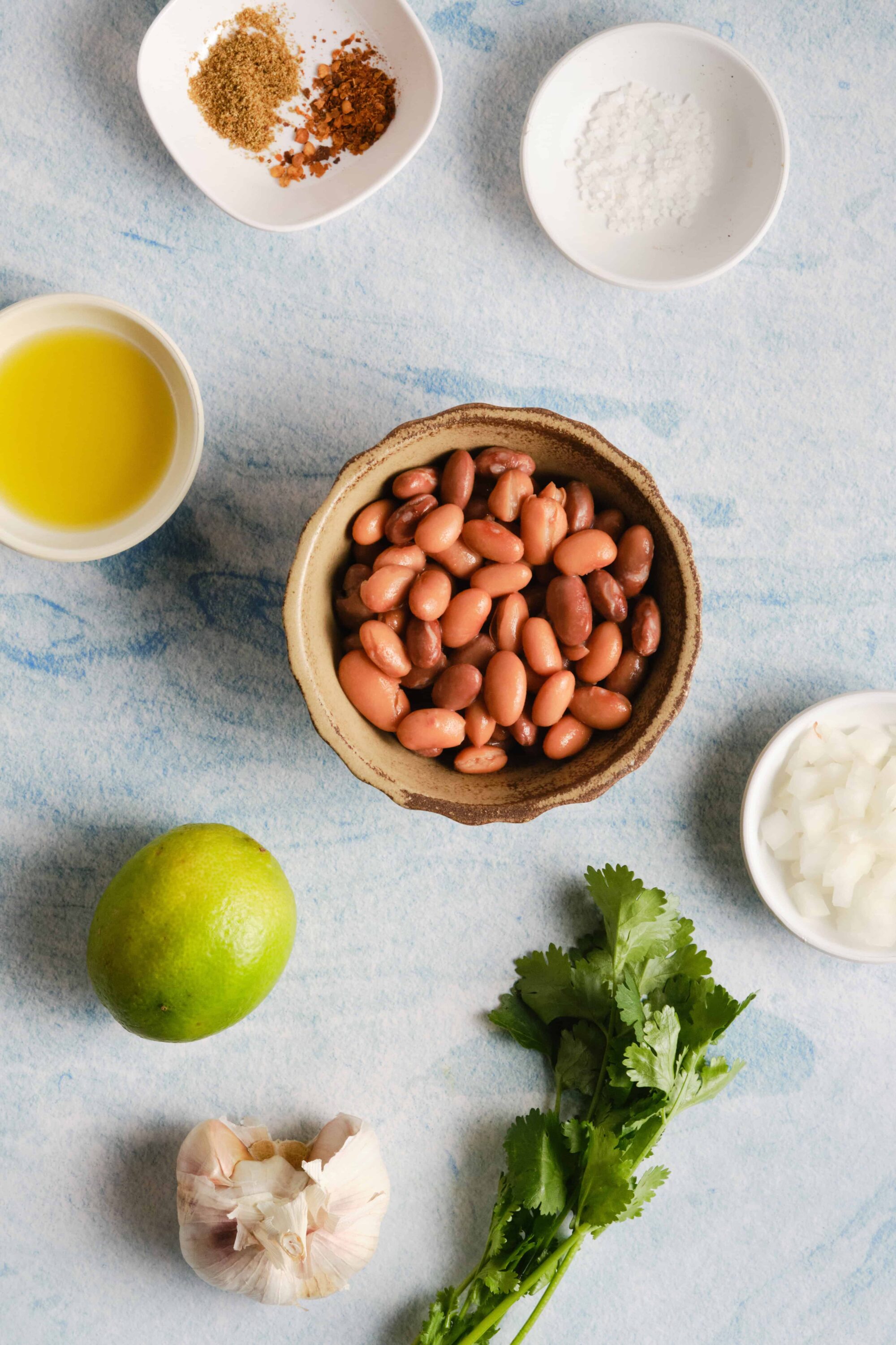 Creamy pinto beans with garlic, lime, and herbs for flavorful vegetarian dishes.